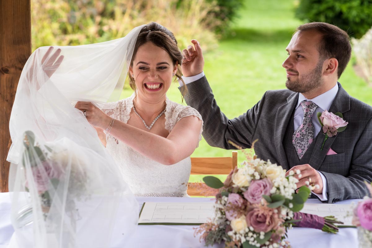 Brides veil blows away during signing of the register