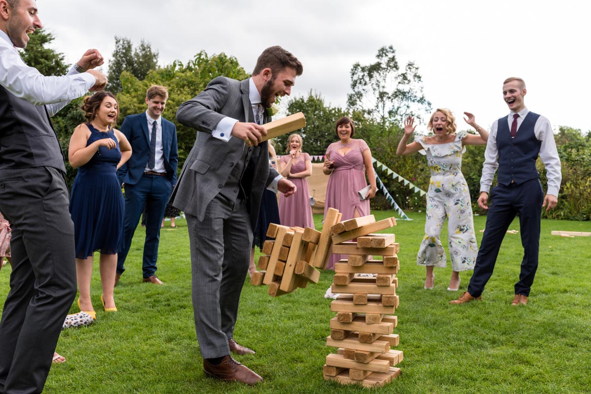 Wedding guests play giant jenga at The Gardens Yalding wedding