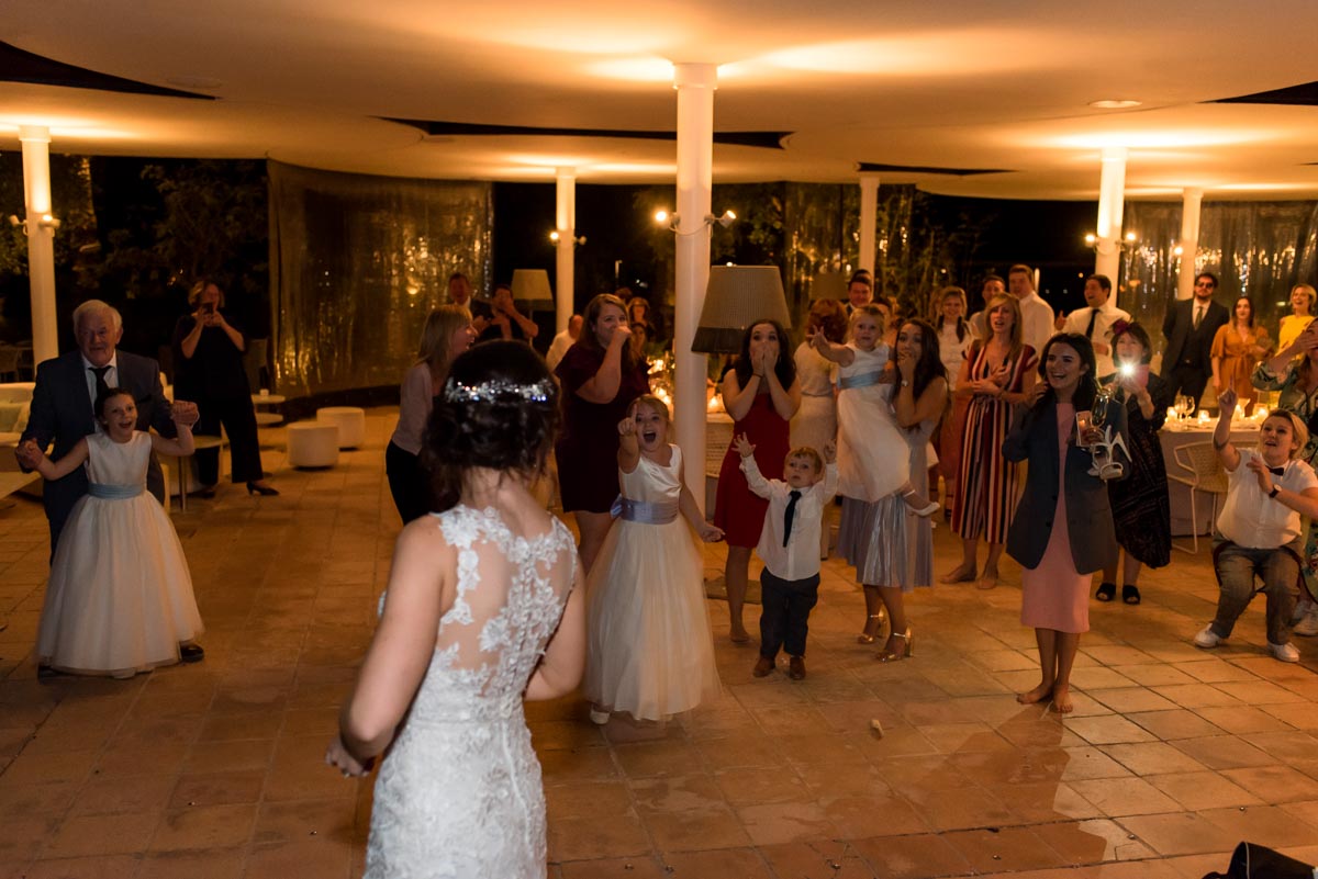photograph of wedding guests after bouquet throw