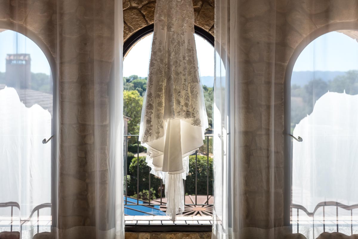 Rebeccas wedding dress photographed hanging in the bridal suite as castell d'emporda