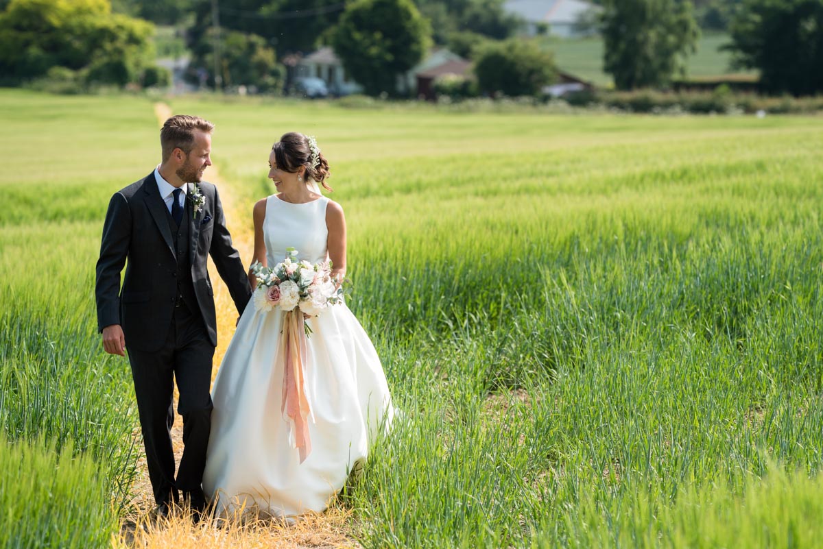Sarah & Craig take a walk on their wedding day at Odo's Barn in Kent