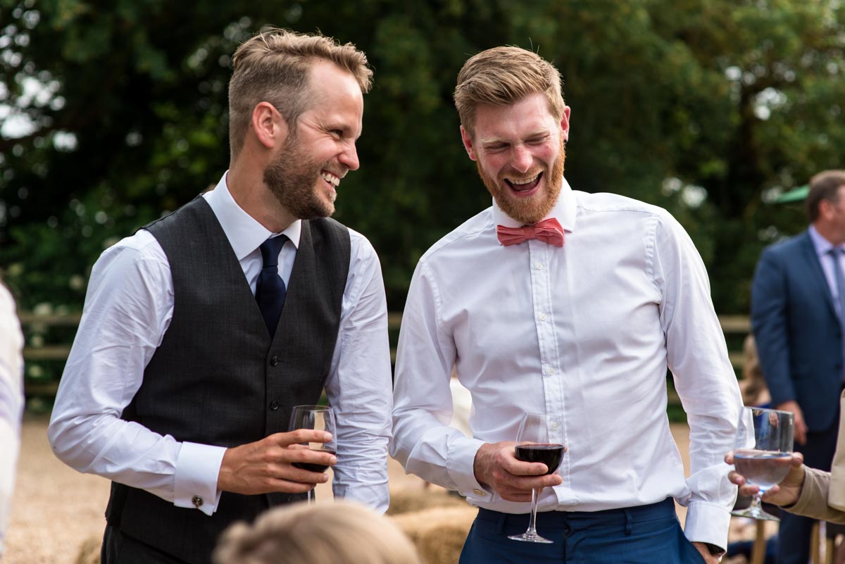 Odo's Barn wedding photography, Craig laughs with friends