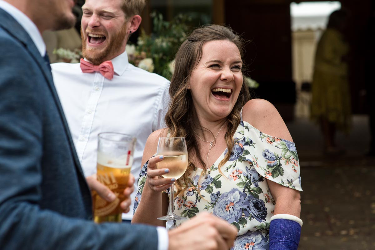 odo's Barn wedding photography, guests laughing during drinks reception