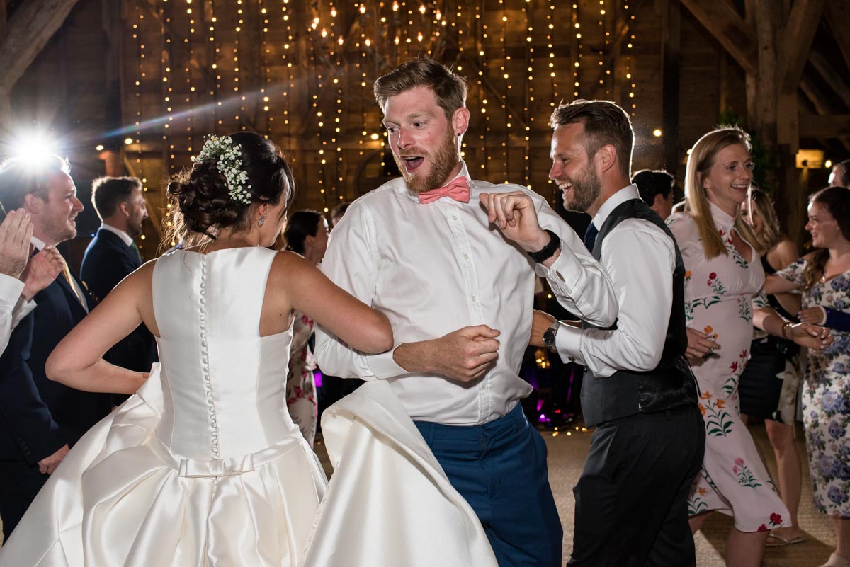 Wedding guests dancing at Sarah and Craigs wedding recception at odo's Barn in Kent
