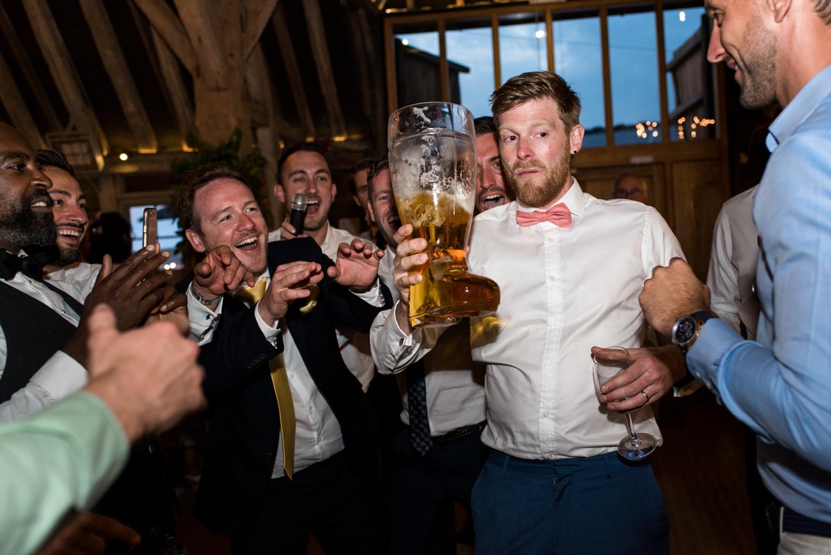 Passing the beer boot at Sarah and Craigs wedding reception at Odo's Barn in Kent