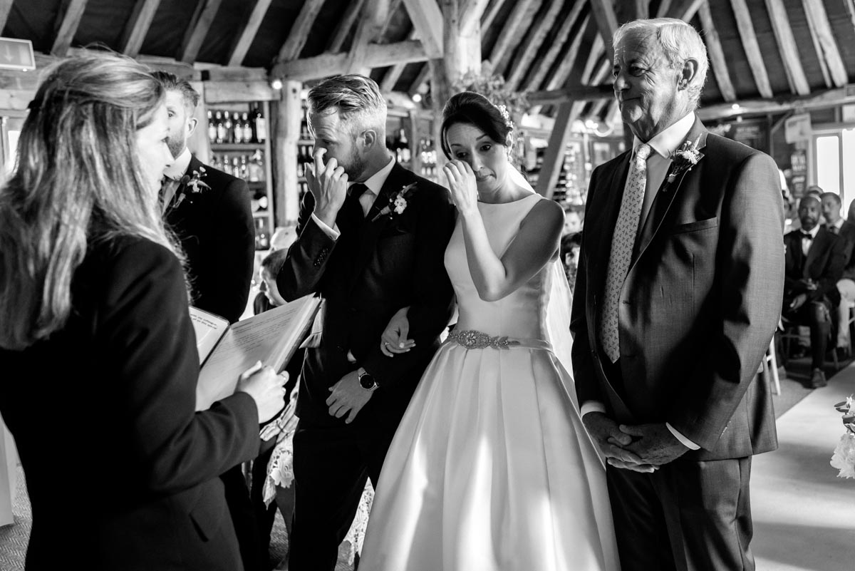 Sarah and Craig shed a tear during their wedding ceremony at Odo's Barn in Kent