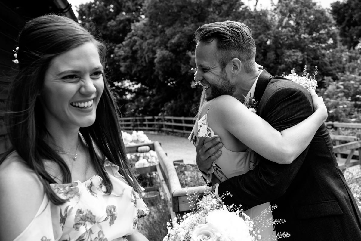 Craig is congratulated by bridesmaids at his wedding at Odo's Barn in Kent