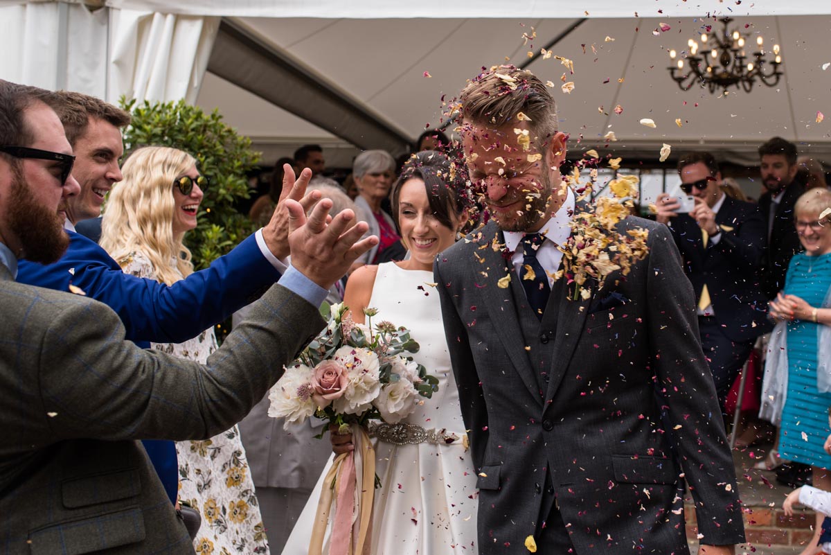Odo's Barn wedding photography,Craig and Sarah have confetti thrown in their faces