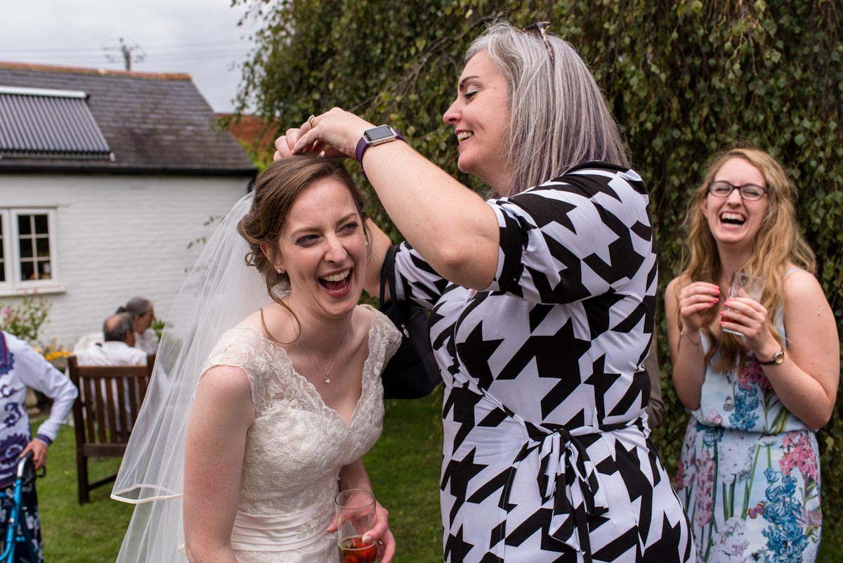 Hannah has her veil adjusted at her Kent country wedding