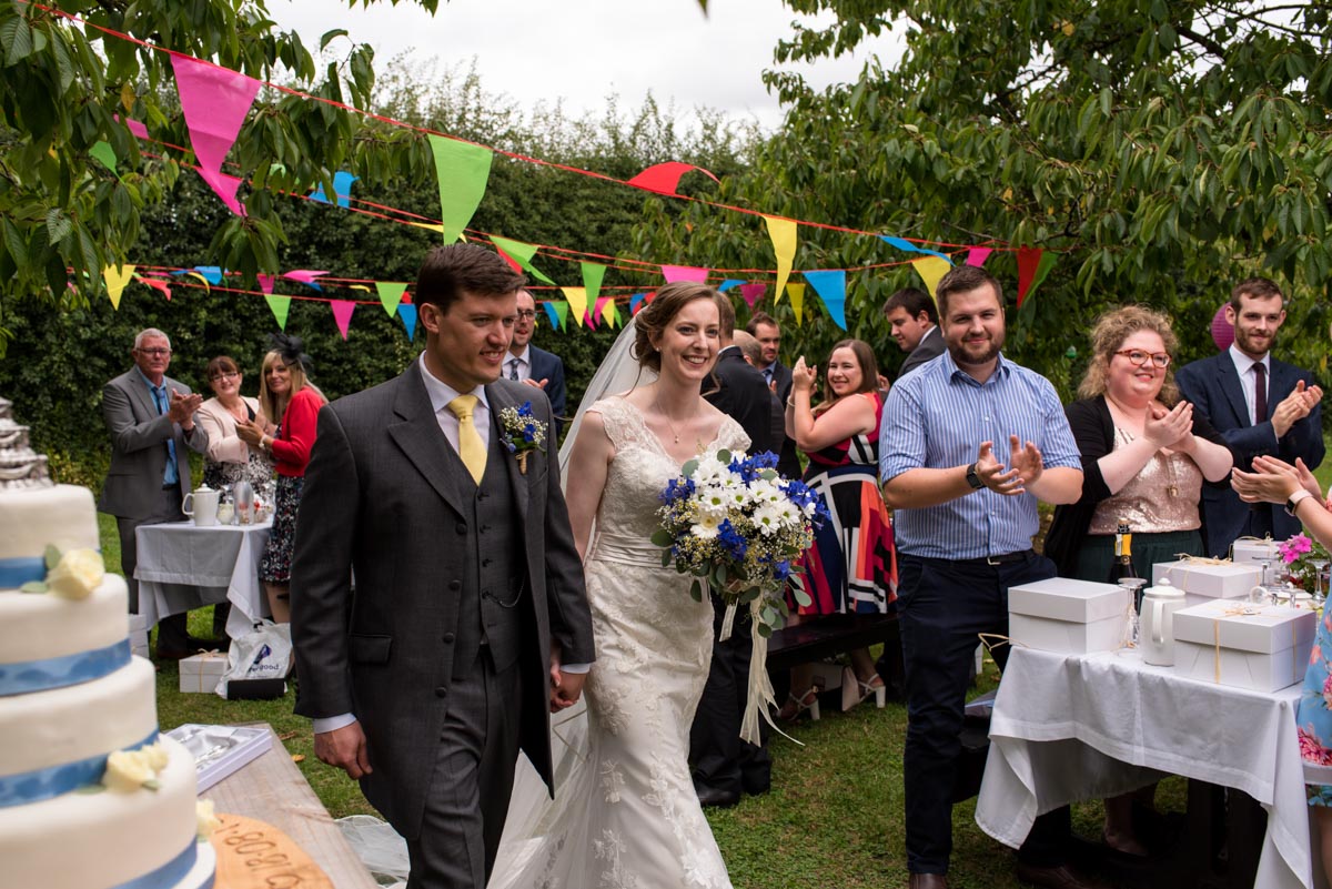 Hannah and Matthew arrive to their orchard wedding reception in kent