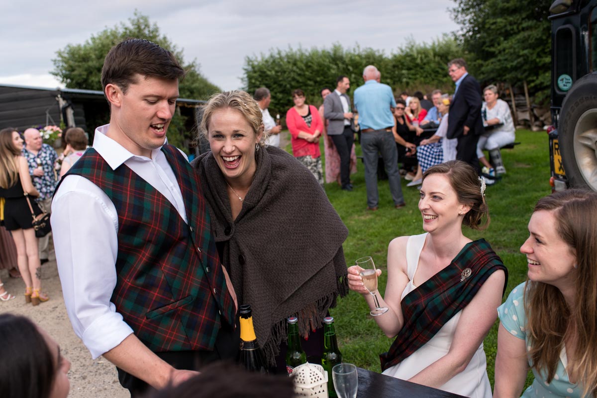 Hannah and Matthew having fun with wedding guests at their Kent country wedding