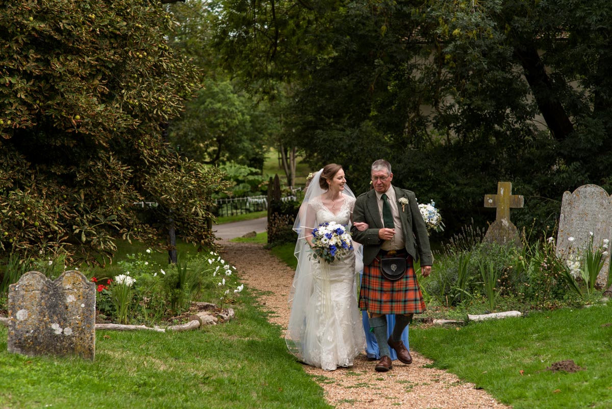 hannah being escourted up the church path on her wedding day in kent