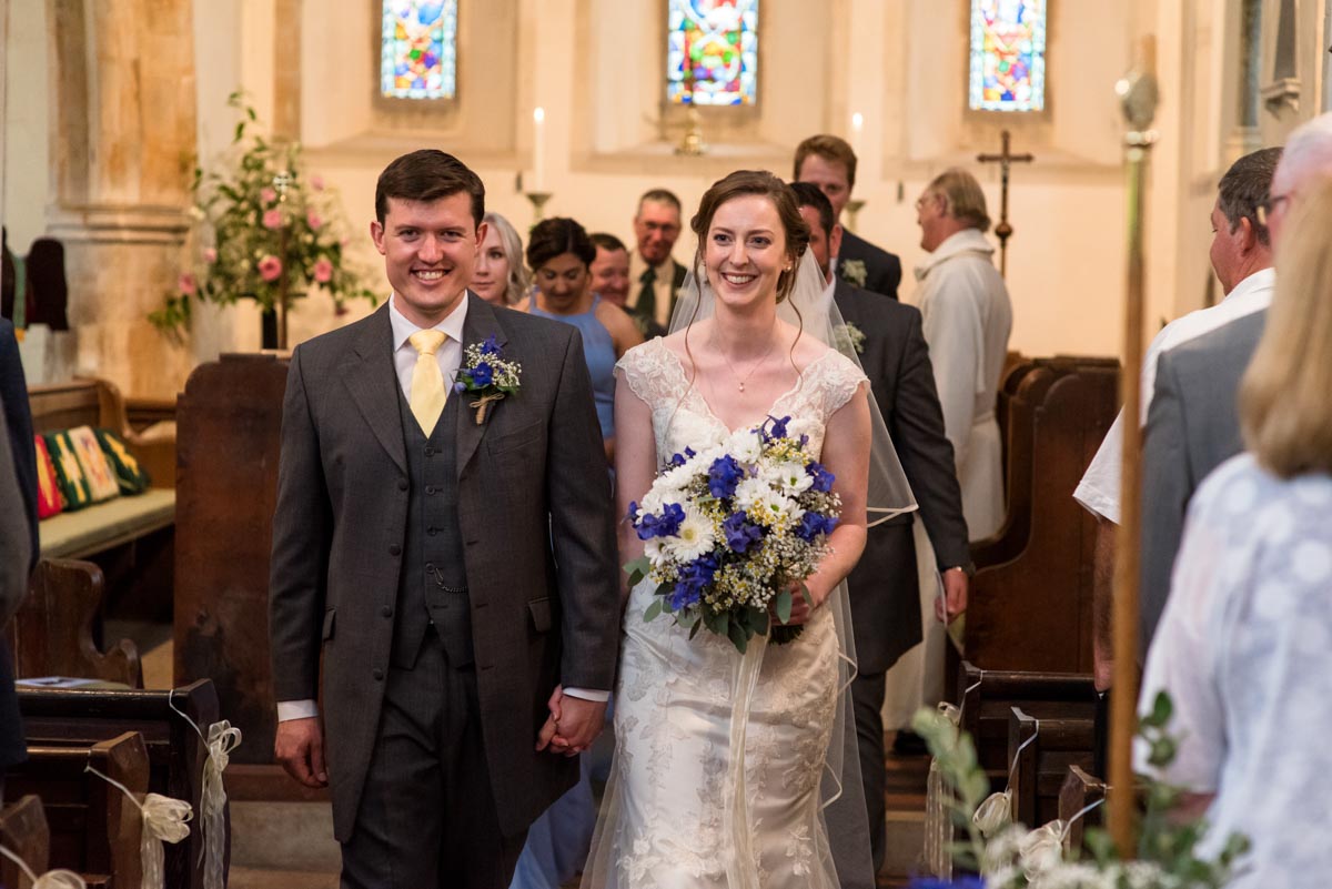 Hannah and Mathew leave church after their Kent church wedding