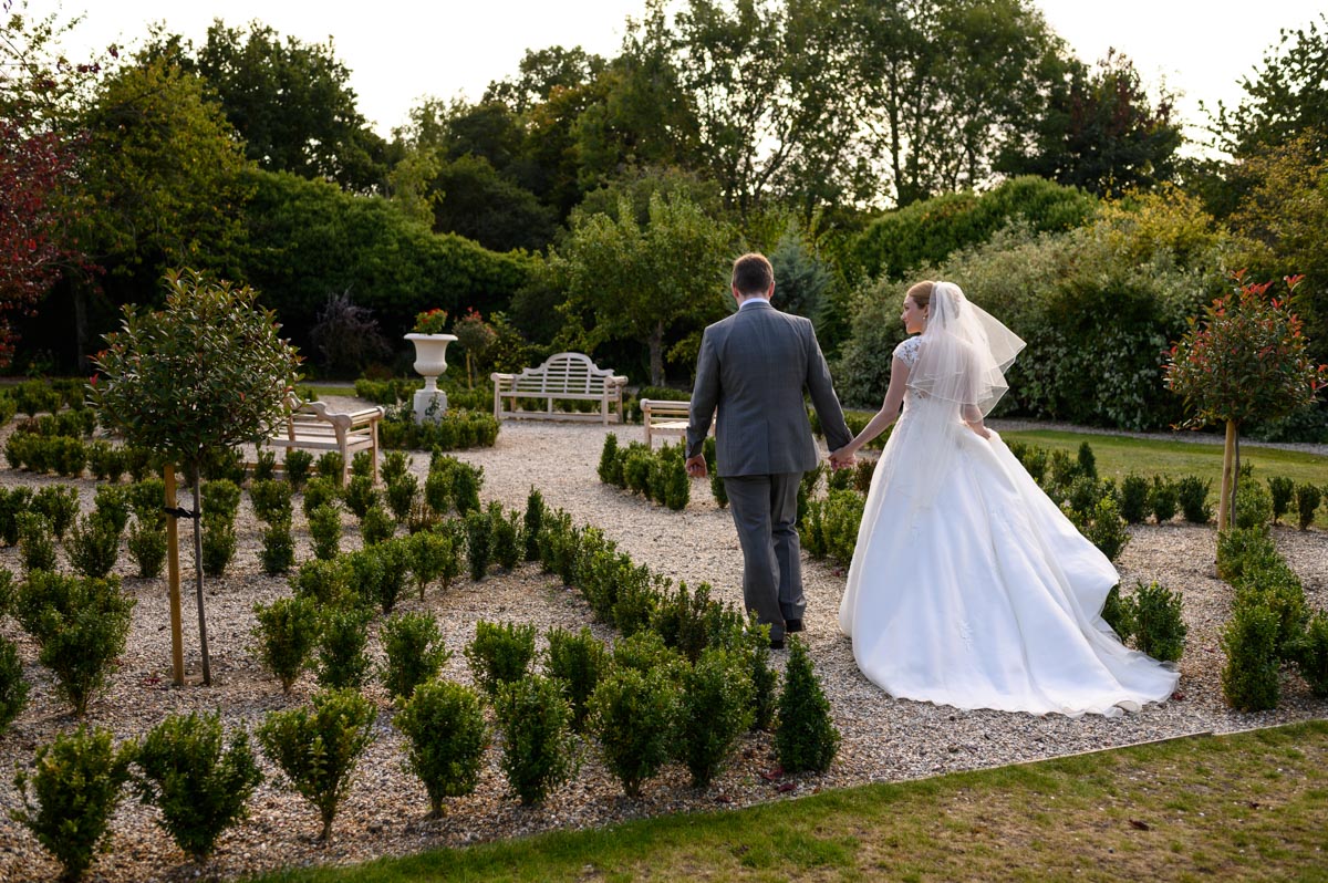 Jack & Bethany walk through gardens at Secret Garden wedding in Kent