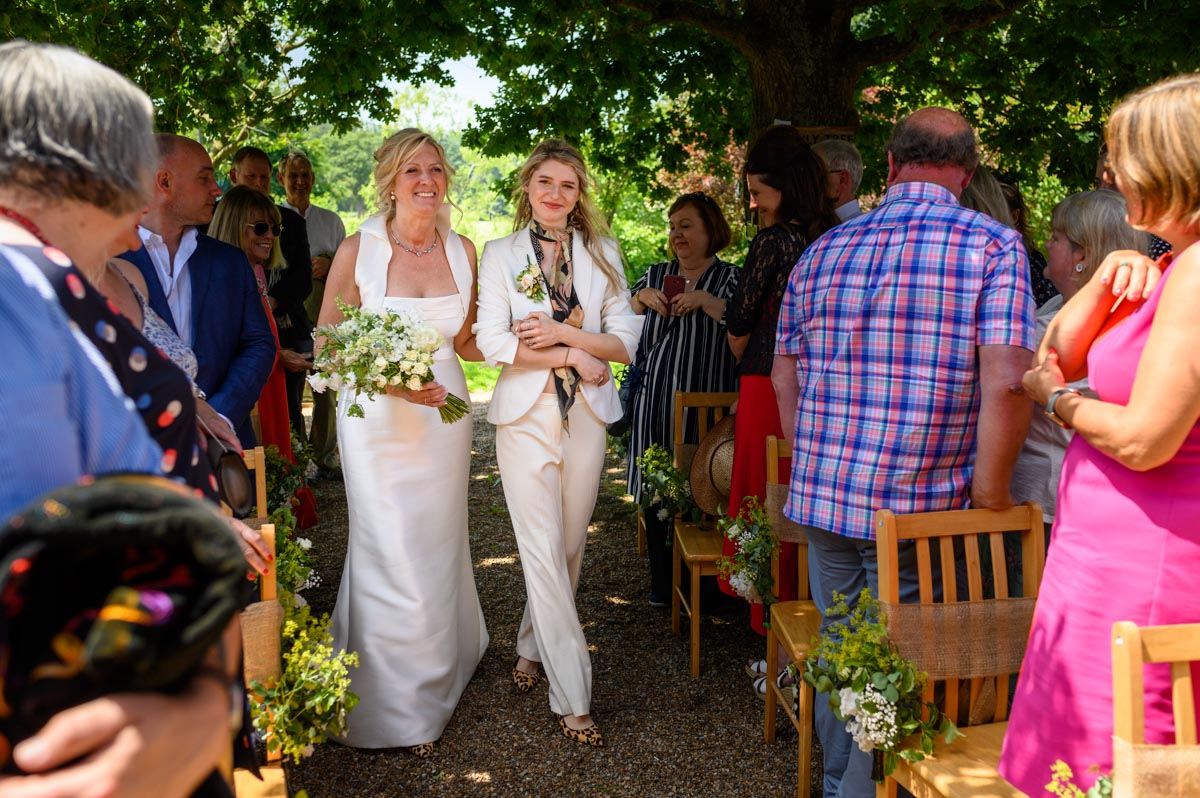 Mariette's walked down the aisle by her daughter at Ratsbury Barn summer wedding