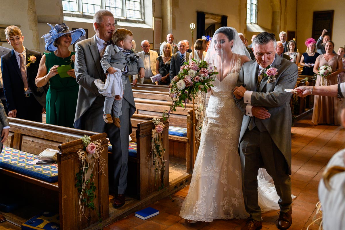 Emma sheds tears coming down the aisle during her Kent church wedding