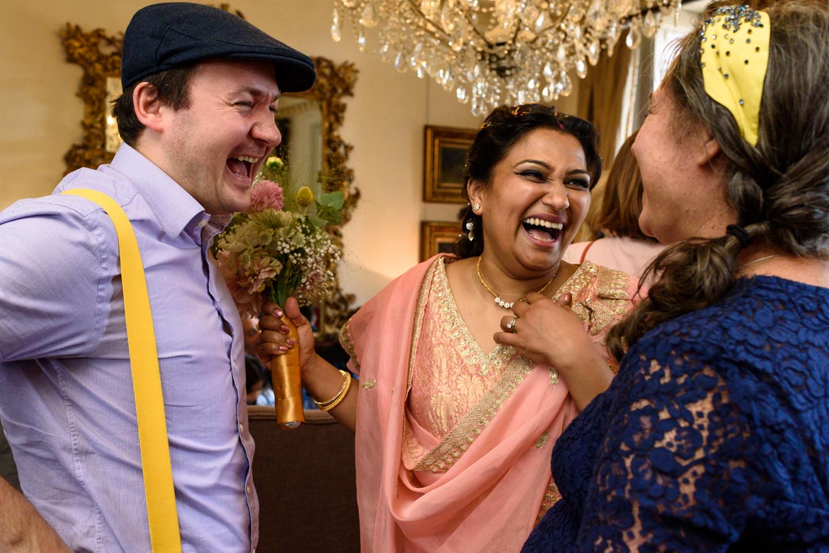 Vinita shares a laugh with wedding guests during her Chilston park wedding reception
