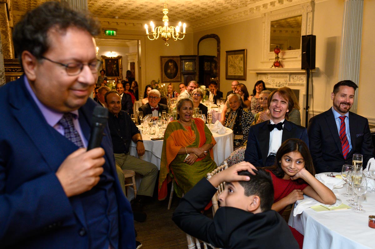Guests enjoy speech at Doug and Vinitas wedding at Chilston Park in Kent