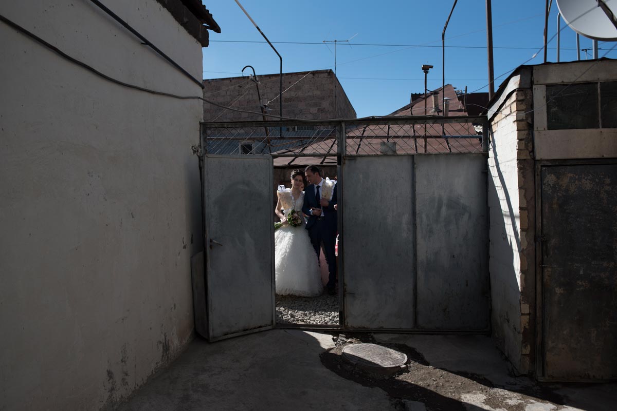 Photograph of Armenian wedding couple about to enter house