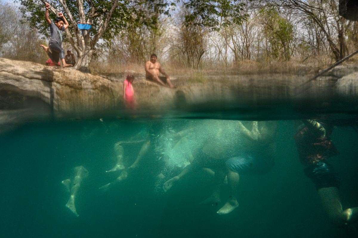swimmers having fun in cenote
