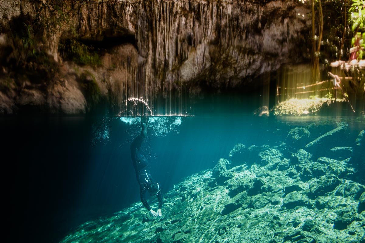 diver diving in cenote