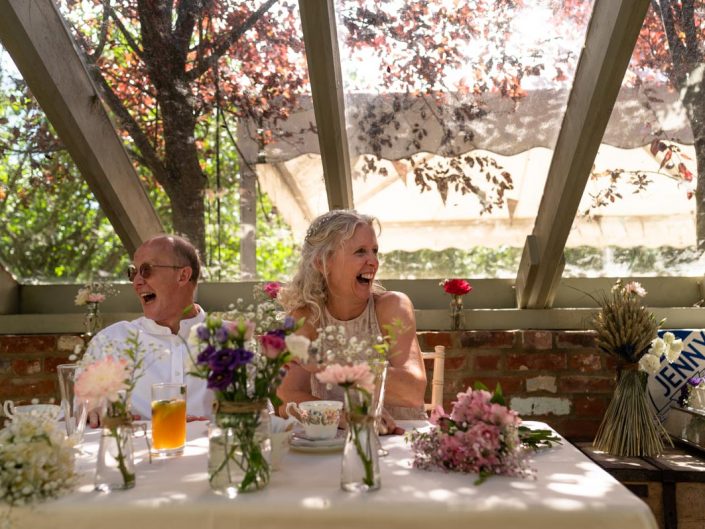 Jenny and Phil enjoy their wedding reception in the glasshouse at the secret garden in Kent