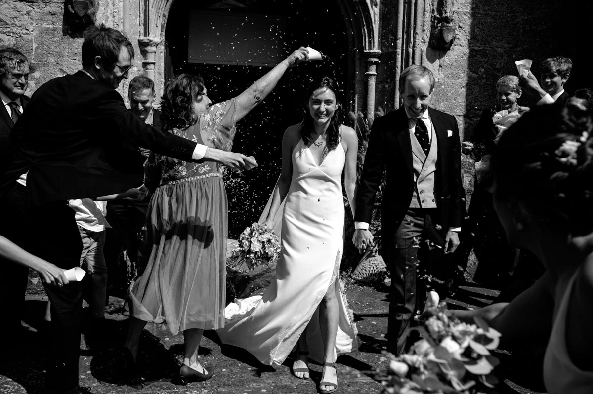 wedding photography best of 2021 confetti photograph of clare and richard leaving the church after kent wedding ceremony