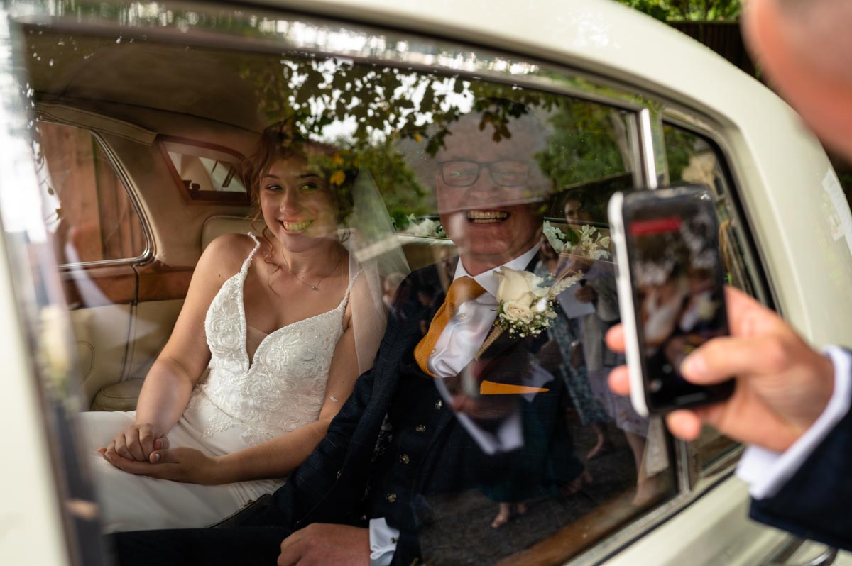 wedding photography best of 2021 photograph of grace and charlie leaving church after their wedding ceremony
