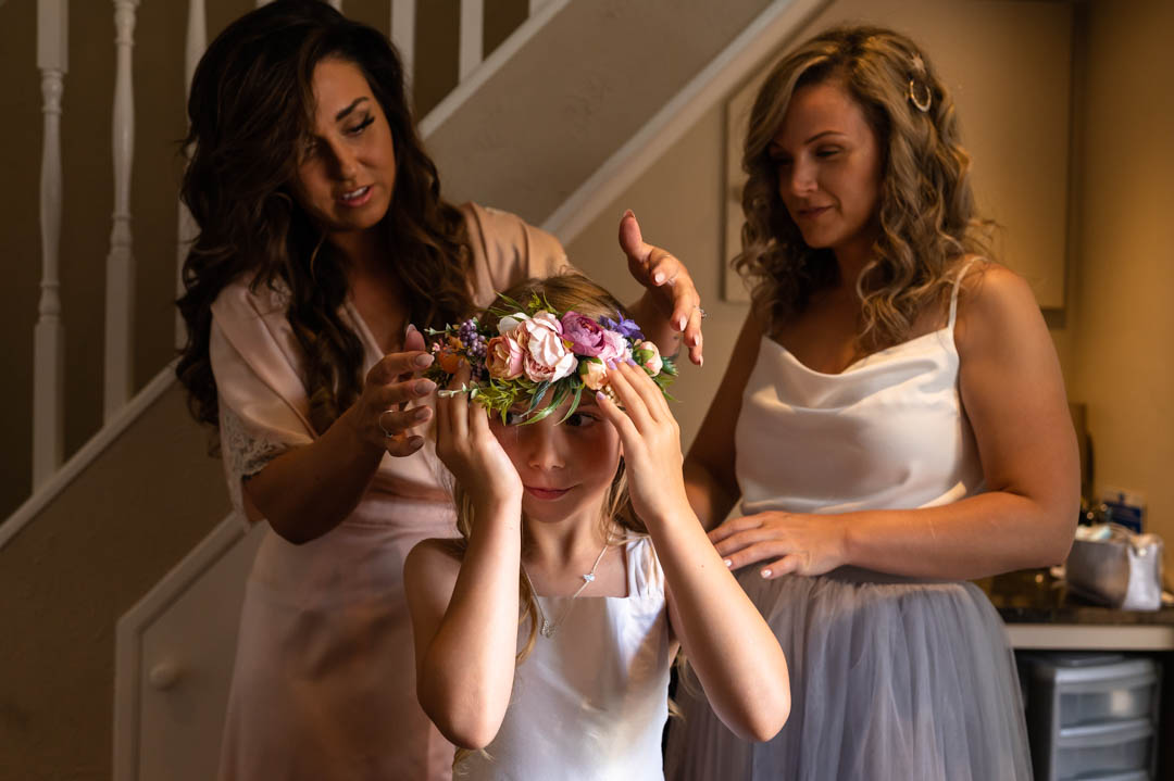 Flower girl has garland placed on her head