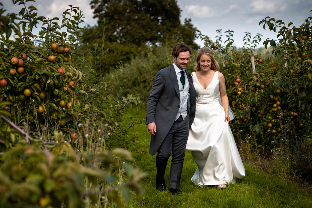 Photograph of Fiona and Chris in the orchards at The Cherry Barn wedding venue