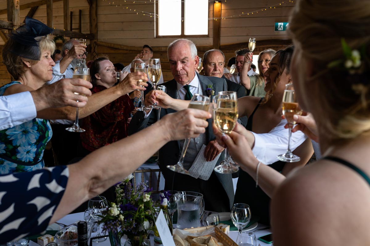 Photograph of brides dad toasting the happy couple suring the speeches at The Cherry Barn wedding venue