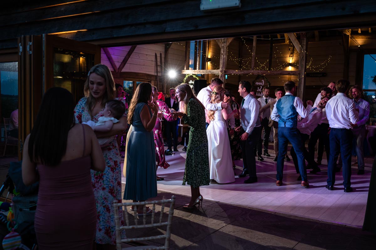 Photograph of wedidng guests on the dancefloor at The Cherry Barn wedding venue in East Sussex