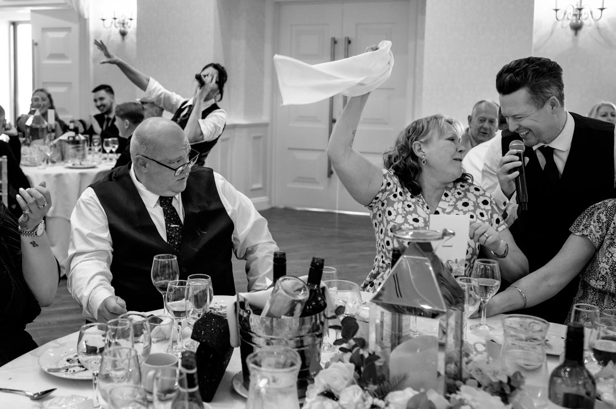 Photograph of wedding guests enjoying singing waiters at Ann and Alans Hythe Imperial Wedding