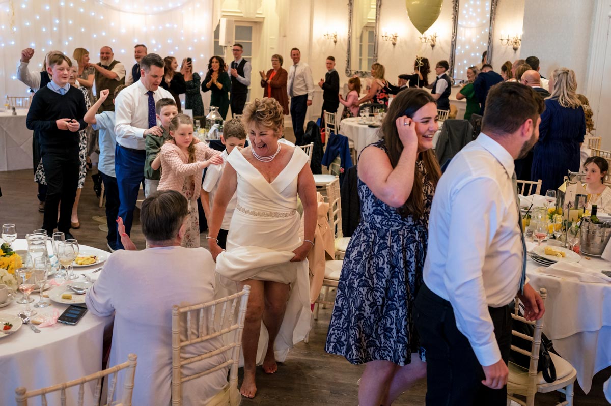 Ann and Alan lead conga at their Hythe Imperial Hotel wedding in Kent