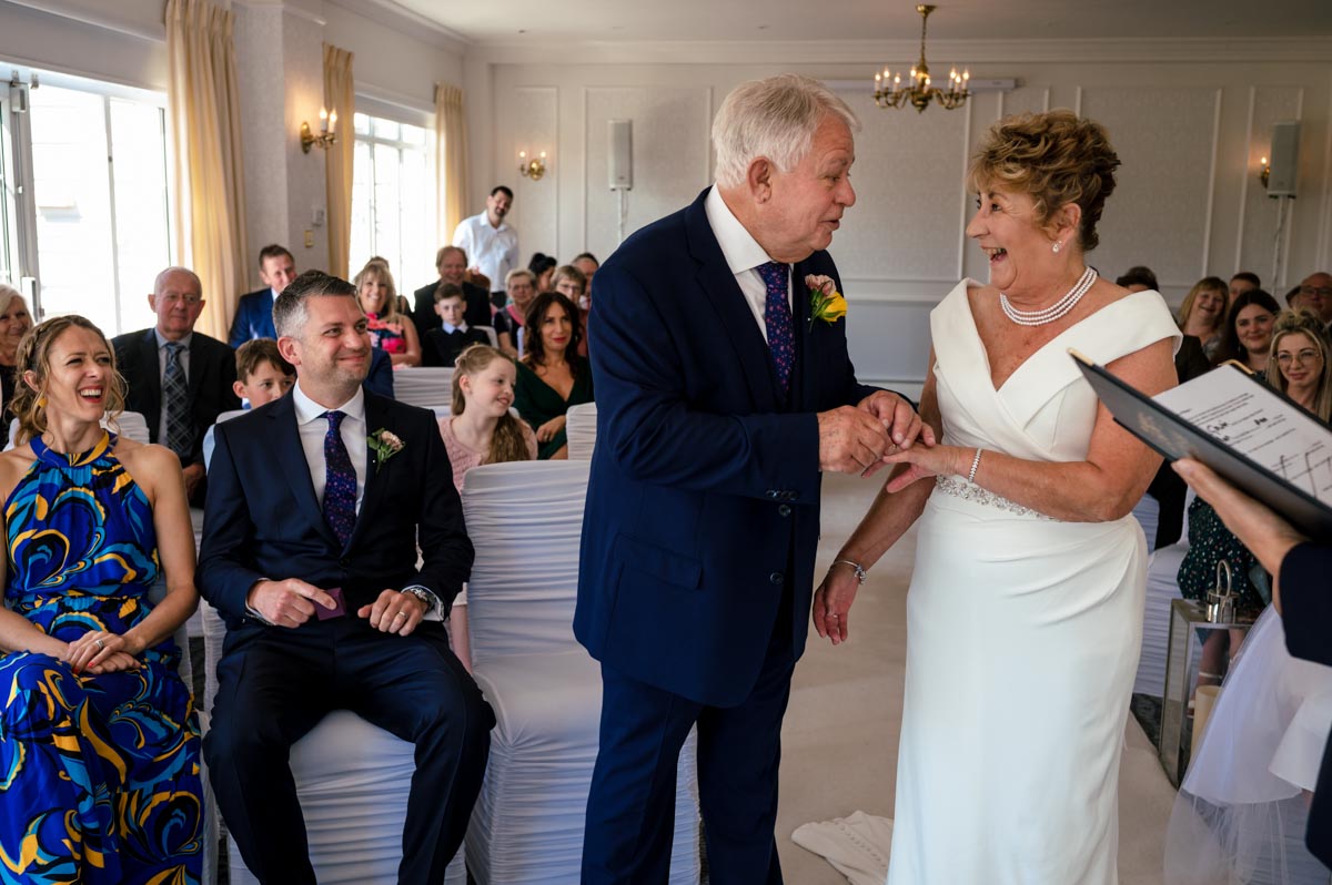 Photograph of exchange of rings during Ann and Alans wedding at the Hythe Imperial Hotel in Kent