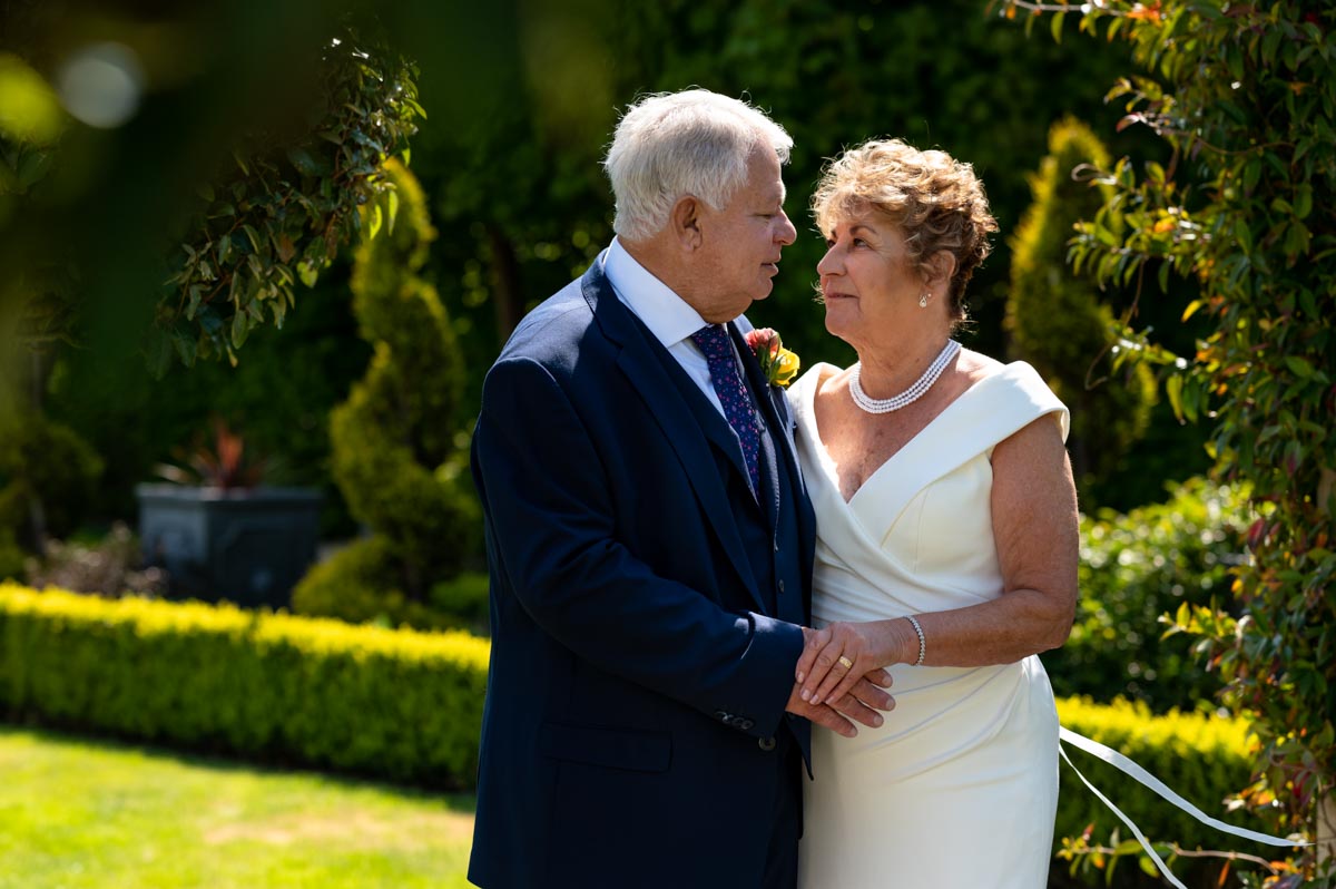 Photograph of Ann and Alan in the gardens at the Hythe Imperial Hotel in Kent after their wedding ceremony