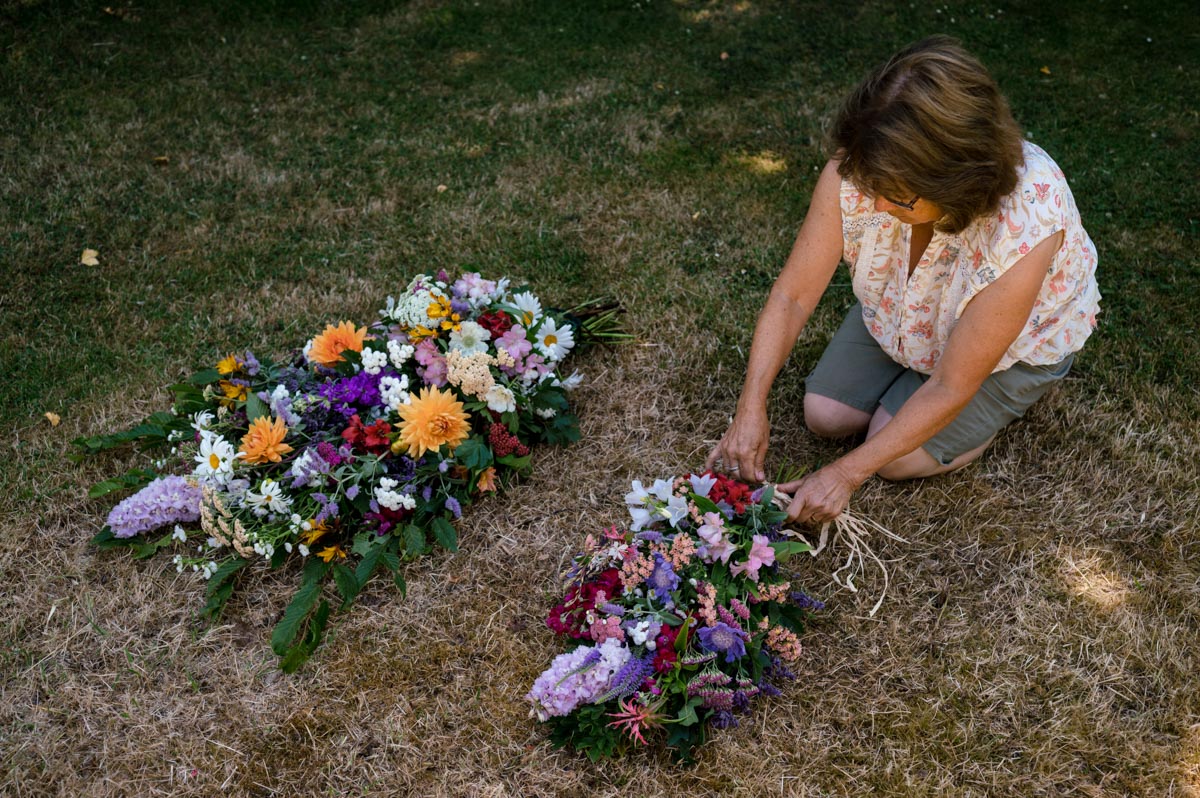 Lin is photographed during day in the lIfe photoshoot tying funeral wreaths