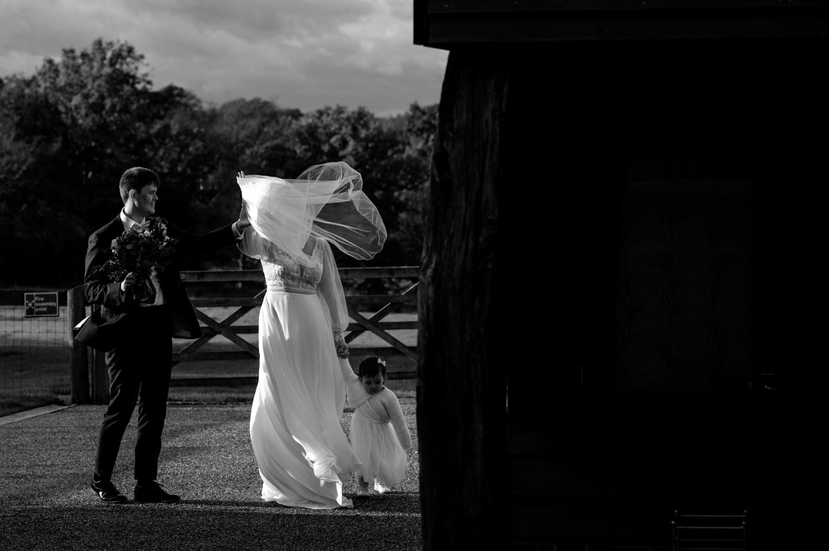 The wind catches brides veil at the Oak barn, Frame Farm wedding venue