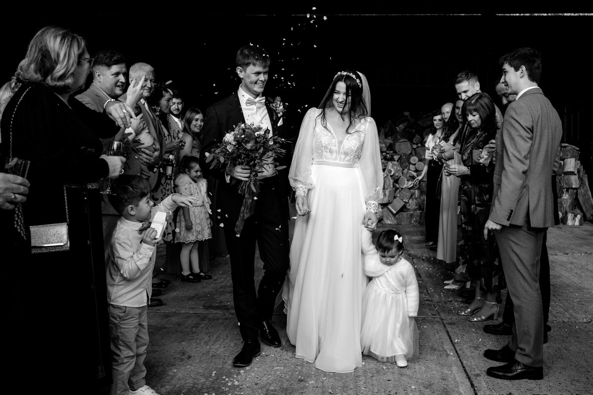 Black and white confetti photo of Sophia and Will during their wedding at The Oak Barn, Frame Farm