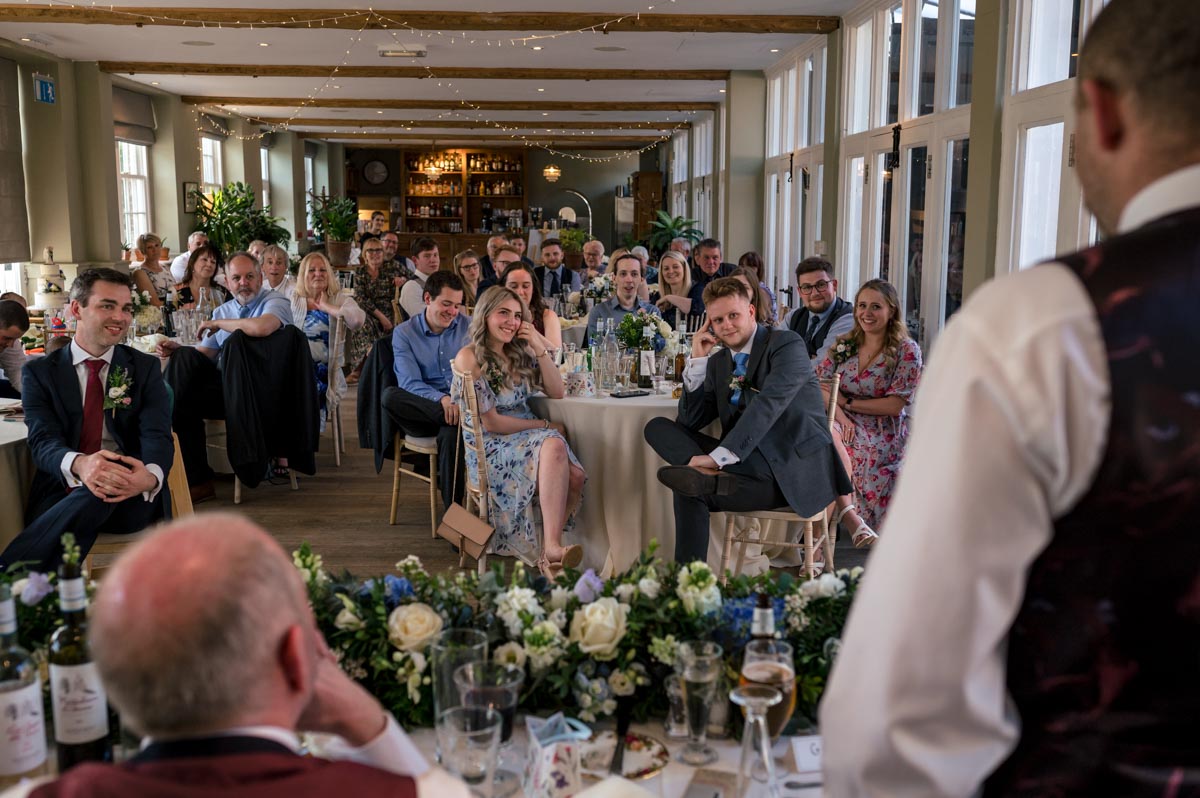 guest enjoy speeches during wedding at the secret garden in kent