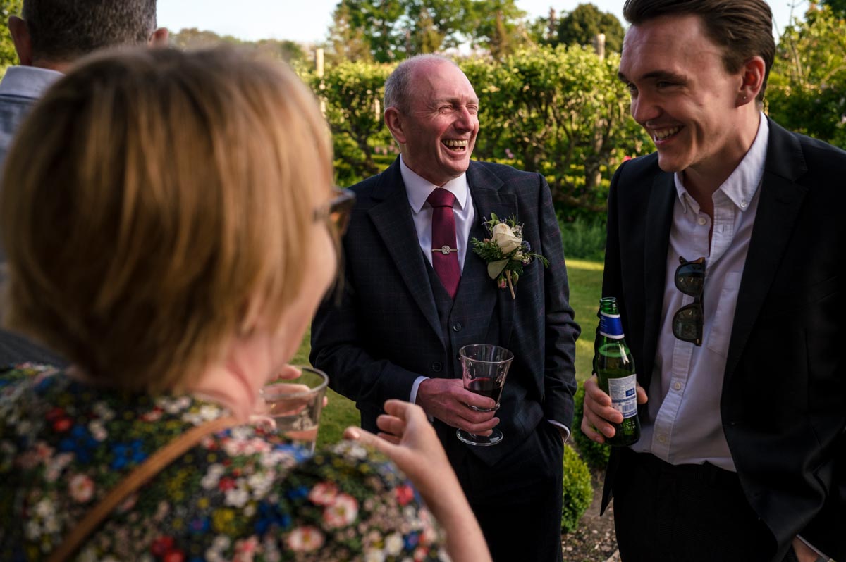 tony laughs with wedding guests at the secret garden in ashford, kent