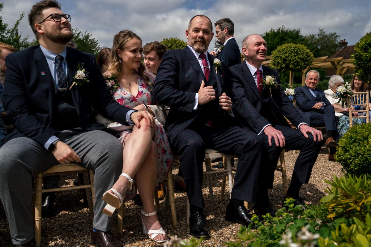 guests seated for Rachel and Tonys wedding in the agzebo at their secret garden wedding