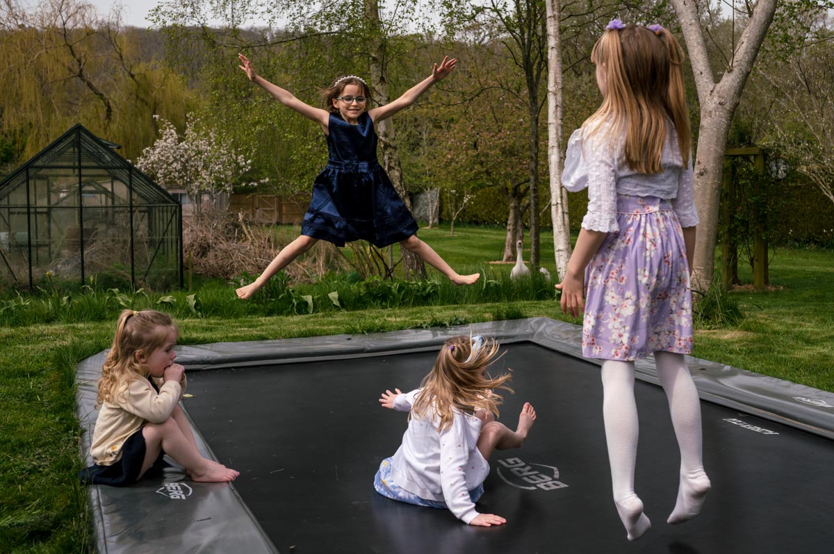 Christening photography Kent. photograph of children playing on trampoline