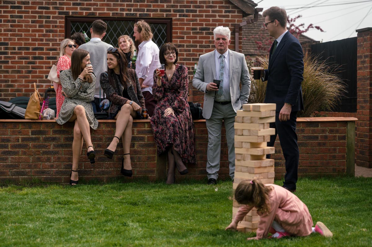 Christening photography Kent. Guests enjoy drinks in family garden after church service
