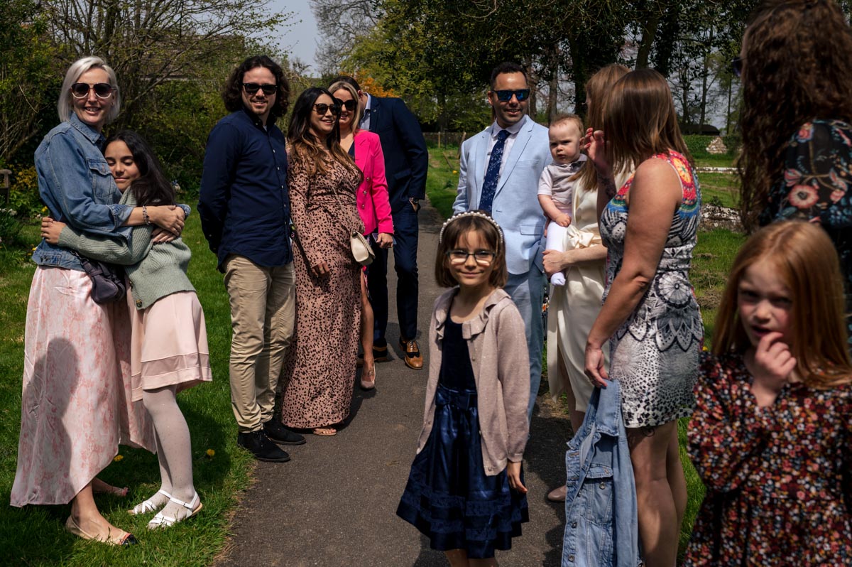 Christening photography Kent. Guests outside church before service