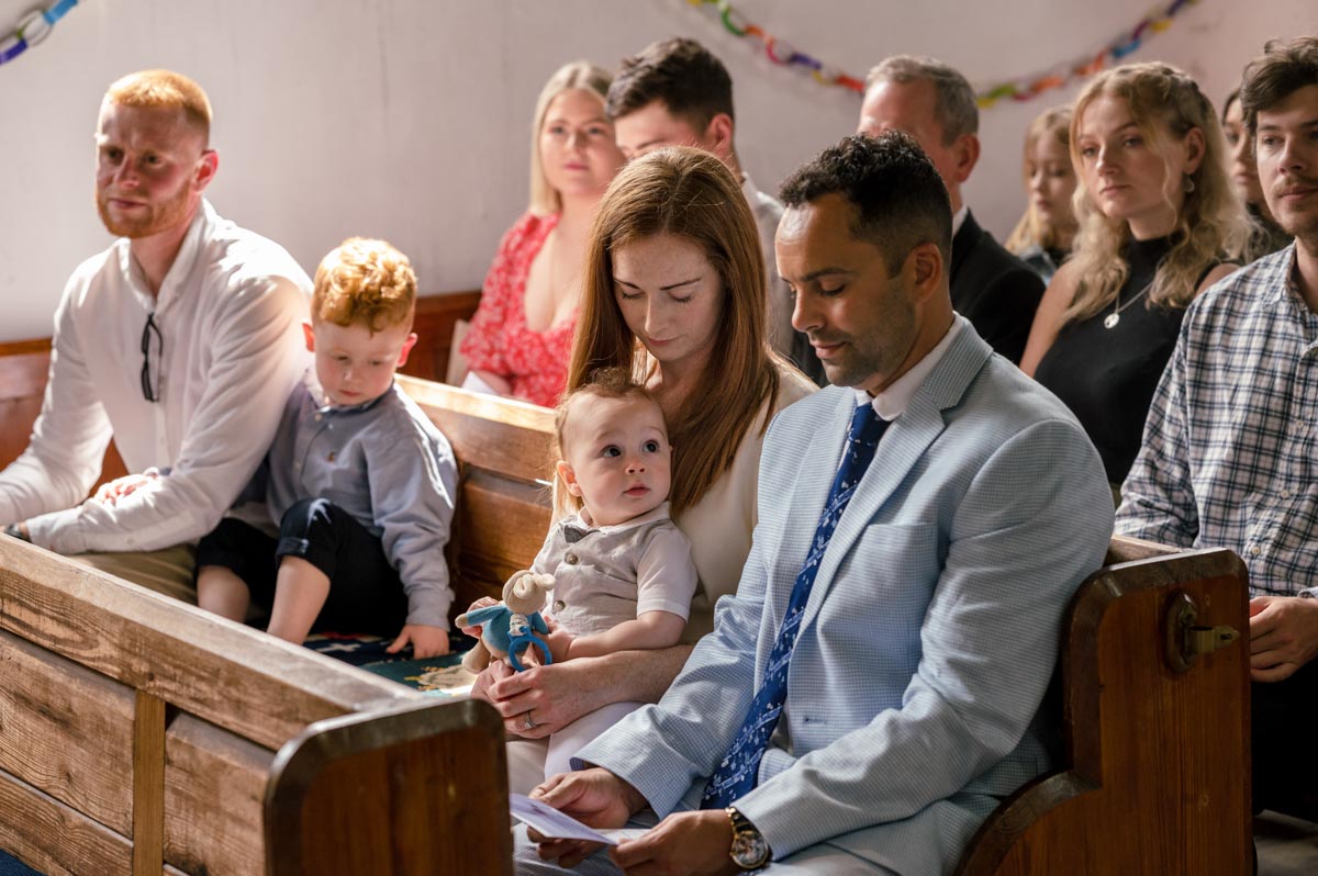 Christening photography Kent. Photo of Rupert and mum and dad during church service