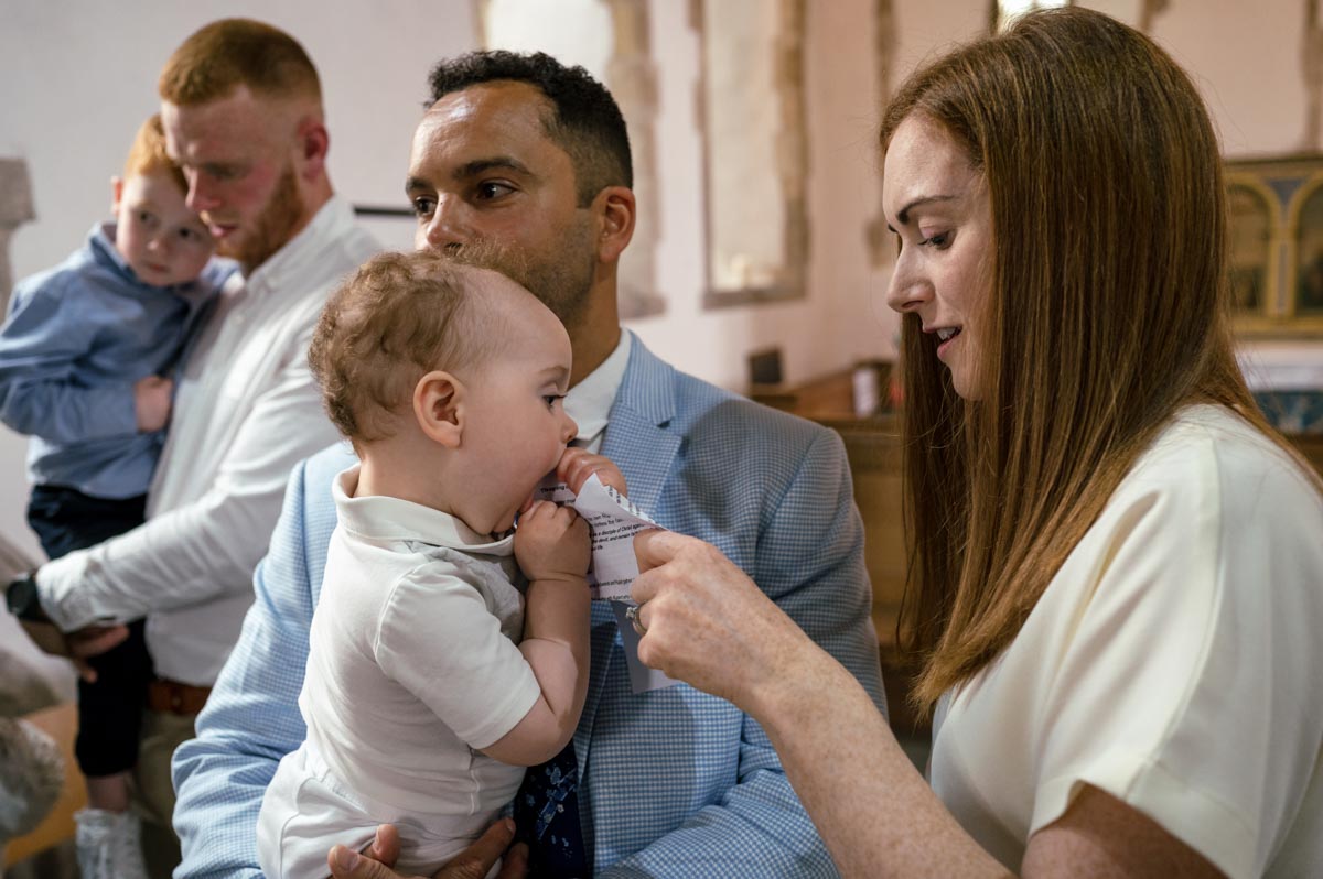 rupert is photographed trying to eat the order of service during christening in Kent