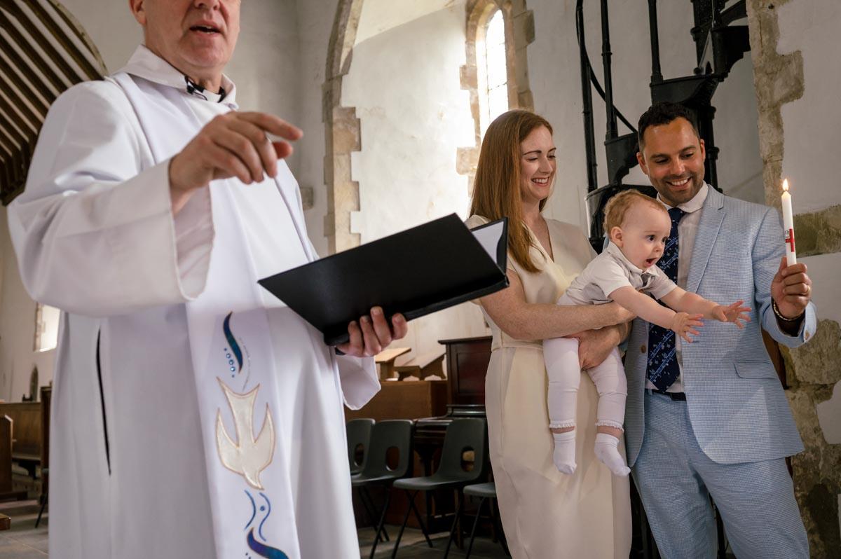Christening photography kent. Vicar and family photographed in church during service
