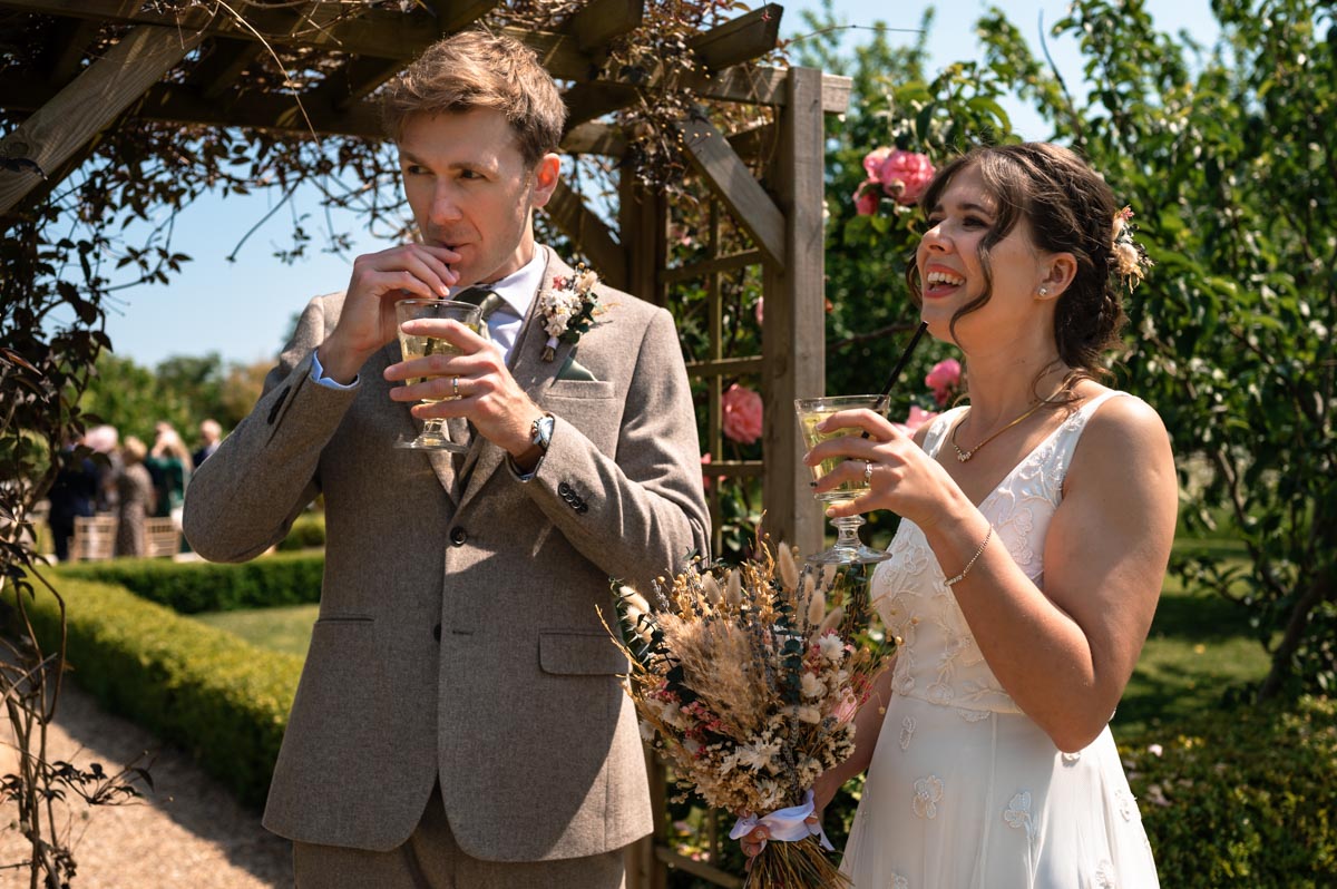 secret garden wedding photography in kent. fred and becca enjoy post ceremony drinks