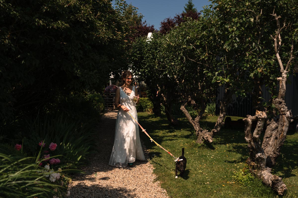 photograph of becca and her dog at her wedding at the secret garden in kent